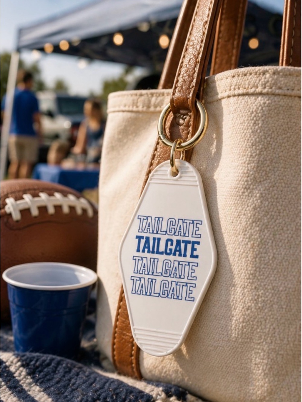Anthropology Keychain with Blue 'TAILGATE' Text